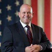 A Man Wearing A Suit And Tie