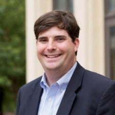Clay McInnis wearing a suit and tie
