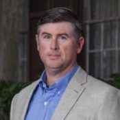 A Man Wearing A Suit And Tie